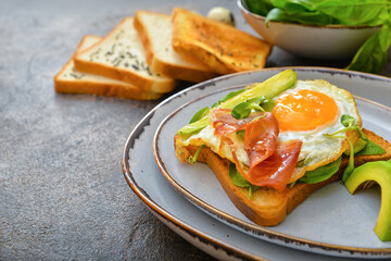 Plate with tasty sandwich on dark background, closeup