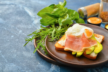 Plate with tasty sandwich on dark color background