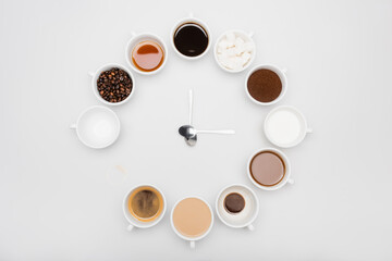 Top view of black and milky coffee in cups near beans and sugar cubes on white