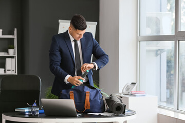 Young businessman going to go to gym after working day in office