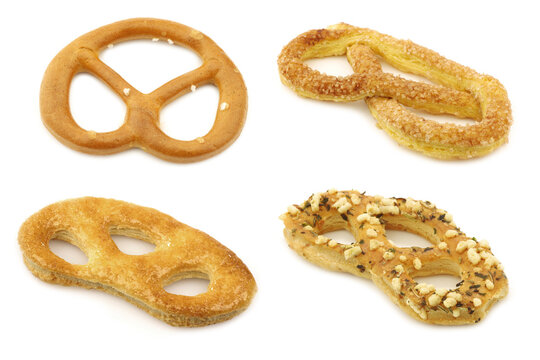 Salty and sweet pretzels on white background