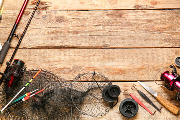 Different fishing equipment on wooden background