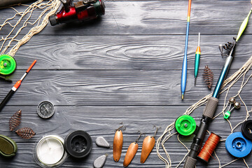 Different fishing equipment on dark wooden background