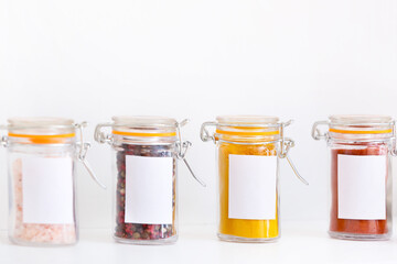 Jars with different spices on white background