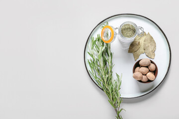 Tray with different spices on light background