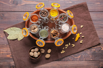 Composition with different spices on wooden background