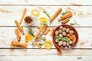 Composition with different spices on light wooden background