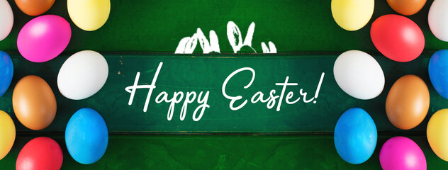 Happy Easter card. colored blue, beige, white Easter eggs in nest top view on wooden background with spring flowers, selective focus image.