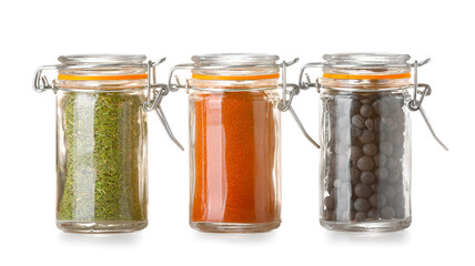 Jars with different spices on white background