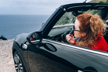 Young woman in cabriolet
