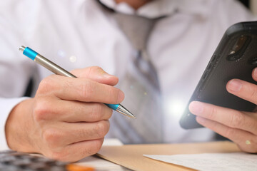 businessman writing on a paper