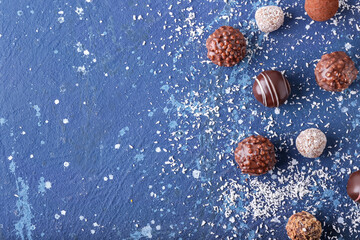 Sweet chocolate candies on color background