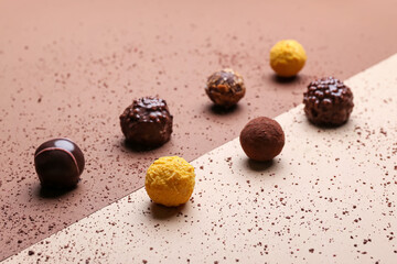 Sweet chocolate candies on color background
