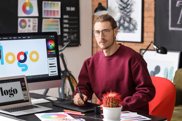 Young male designer working in office