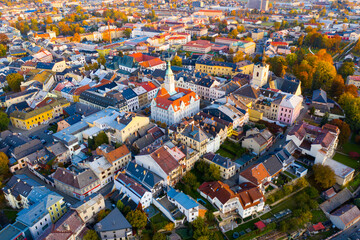 Panoramic aerial view of autumn landscape of Czech town of Sumperk with Church of Saint John Baptist and Town hall at sunrise, Olomouc Region