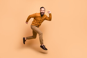 Fototapeta na wymiar Full body profile photo of cheerful handsome guy toothy smile look camera isolated on beige color background