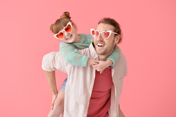 Portrait of happy father and daughter on color background