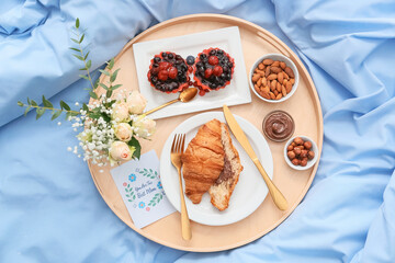 Tasty breakfast for mother on bed