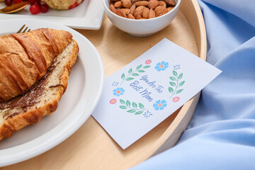 Tasty breakfast for mother on bed