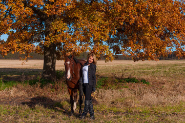 Fototapeta premium beautiful woman walking with horse