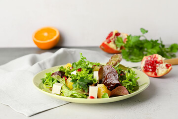 Plate of fresh salad with vegetables on light background