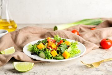 Plate of fresh salad with vegetables on table