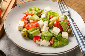 Plate with fresh Greek salad on table, closeup