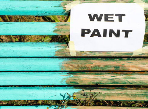 Wet paint sign on a fresh painted bench