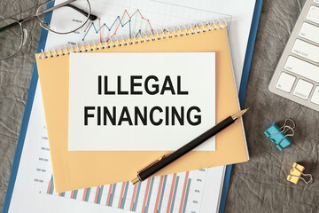 Illegal financing is written in a document on the office desk