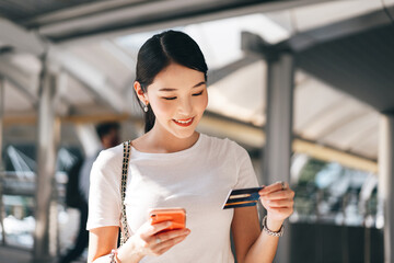 Young adult business asian woman consumer using creadit card and smartphone for shopping online.