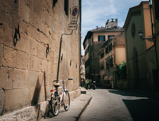 Bicycle on Traditional Italian Streets and Urban Setting with Summer Sun, Florence, Italy