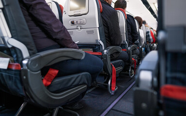 low angle of air passengers sitting on their seats in Turkish airlines flight before takeoff
