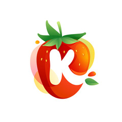 Letter K logo on a tasty ripe Strawberry with green leaves and juice splashes.