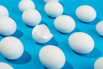 broken pattern with eggs and egg shell on blue background