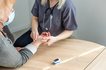 Doctor measuring blood pressure of senior patient