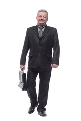 Confident businessman walking along with briefcase