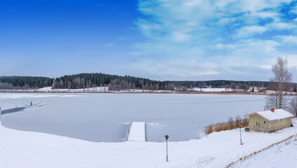 Fototapeta na wymiar Snow and frozen lake in Finland