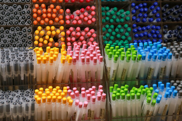 Colorful pens on display boxes in a stationery store