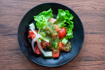 Salmon Salad, cherry tomatoes,. Homemade food. Concept for a tasty and healthy meal. On wood background. Top view. Close up