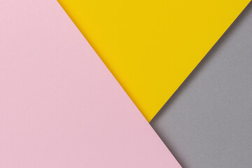 Creative abstract yellow, pink and gray color geometric paper compositon background, top view