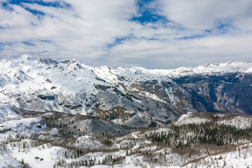 High mountains under snow in the winter for alpine resort skiing. Aerial view with drone.