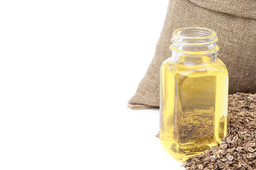 Dill essential oil. Glass bottle of dill oil.Dill in a sack of isolated on a white background. Fennel. Healthy food. Vegan food. Superfood and vitamins. Nature oil.