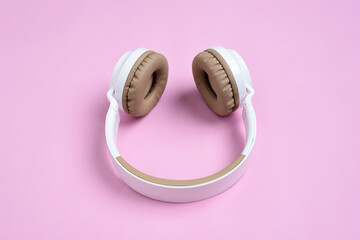 Close-up photo of cool headphone on pink background. Music concept.