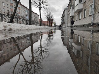 Sidewalk drenched with water from melted snow