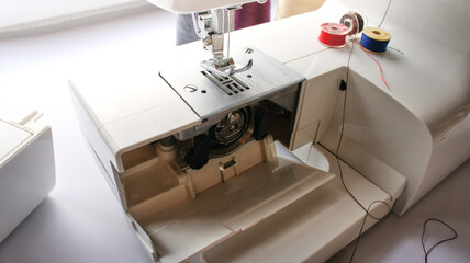 electric sewing machine with thread and bobbin