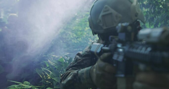 Silhouette of the Fully Equipped Soldier Moving Through Smokey Forest. Military action