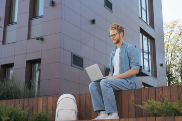 Student studying, exam preparation, distance learning, online education concept. Handsome red...