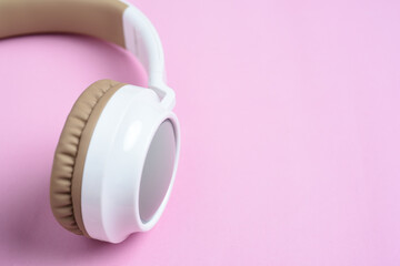 Close-up photo of cool headphone on pink background. Music concept.