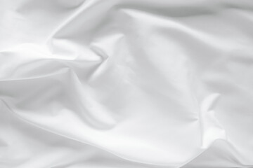 Abstract white fabric texture background. Cloth soft wave. Creases of satin, silk, and cotton.