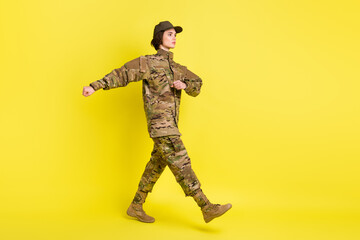 Full size profile photo of calm focused girl look empty space marching isolated on yellow color background